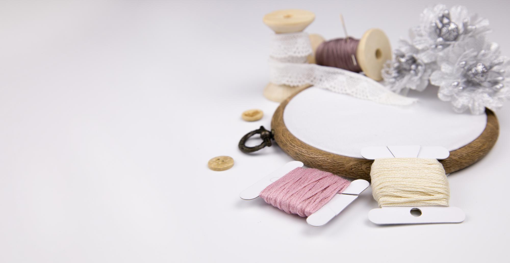 Atelier workspace with threads and embroidery hoop